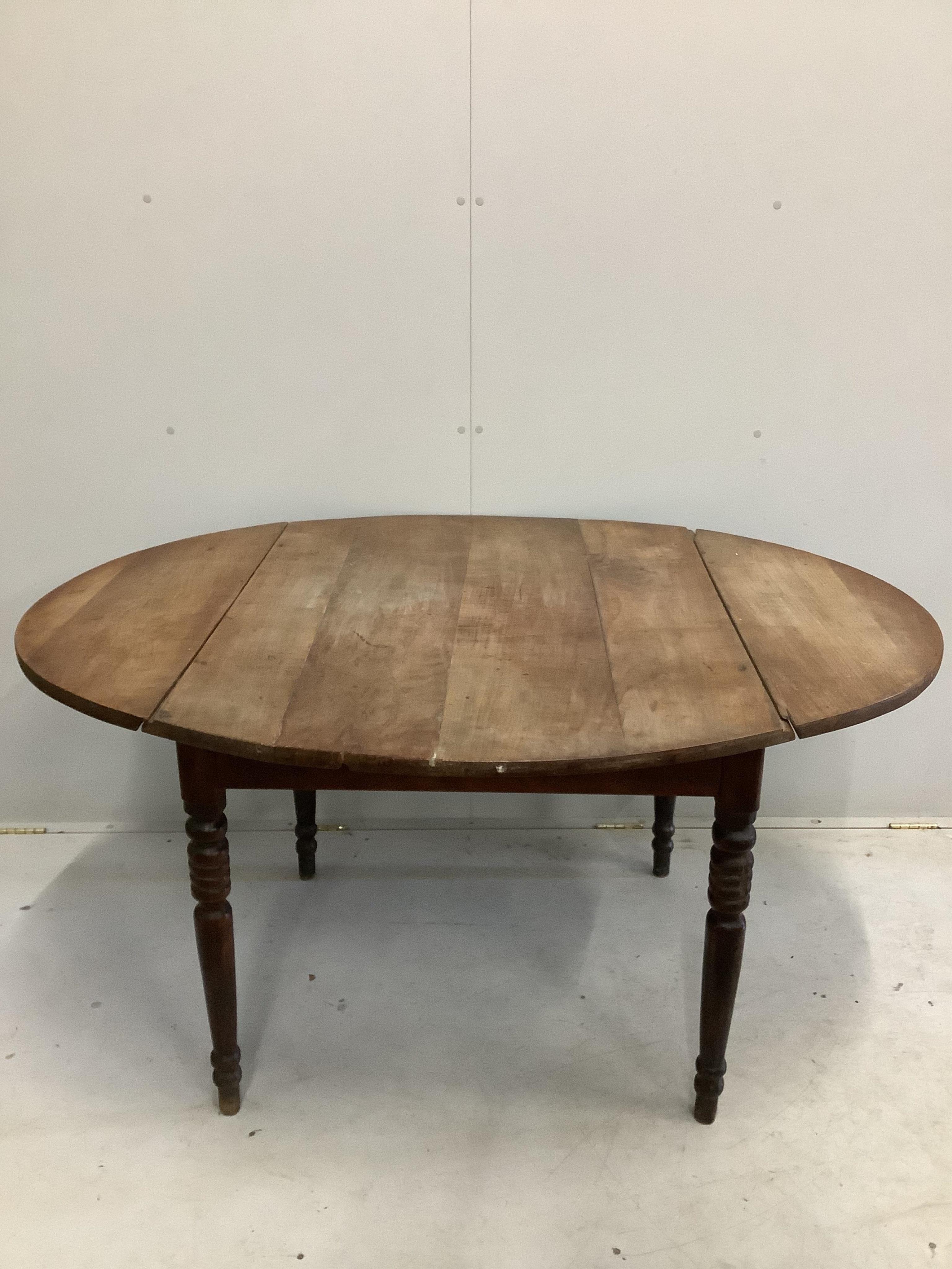 A large 19th century French cherry drop leaf dining table, width 112cm, 142cm extended, height 73cm. Condition - poor to fair